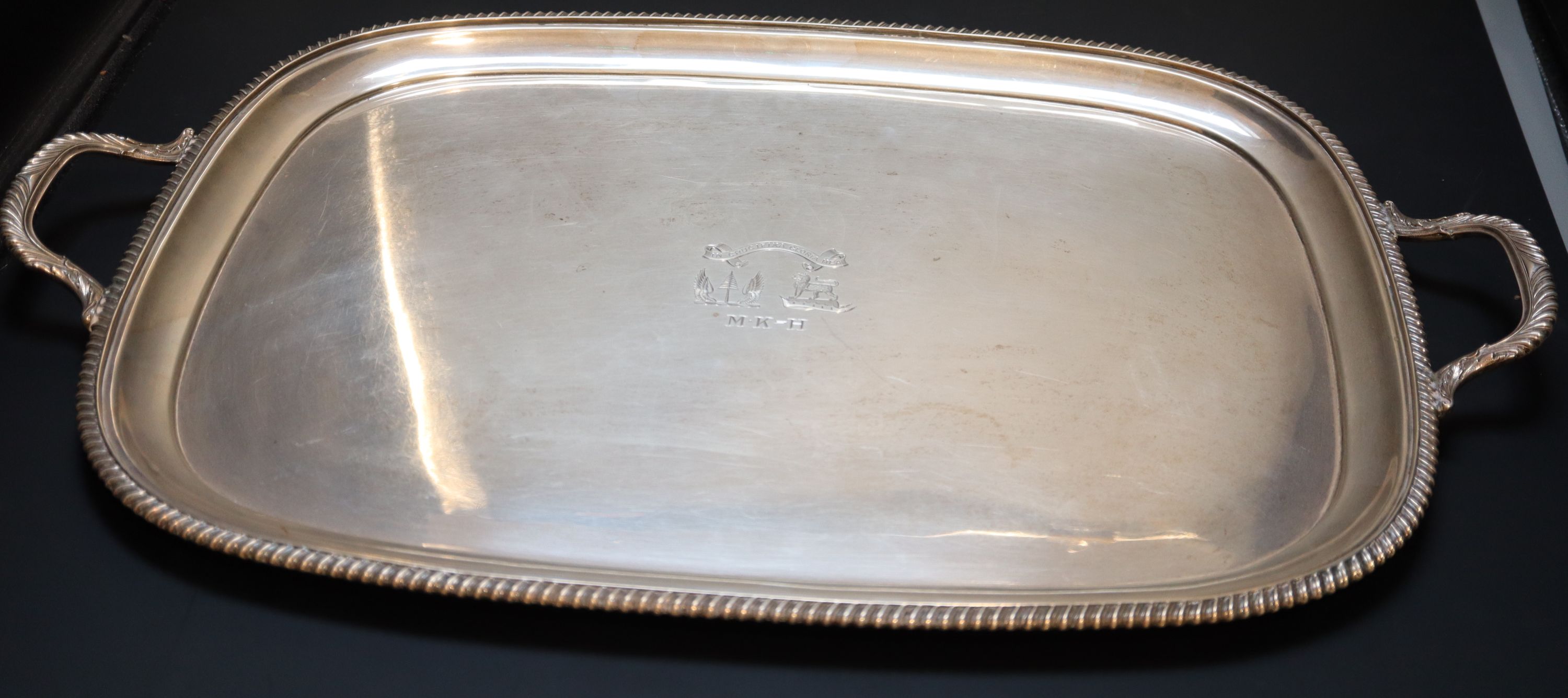 A George V silver two handled tea tray, 64.7cm over handles, 98oz.